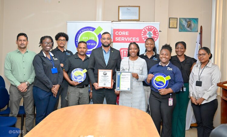 (L-R) GFSL Quality Officer, Abidin Mohamed, PS-Ministry of Home Affairs Andre Ally and Director(ag) of GFSL Ms. Charis Griffith along with staff of GFSL