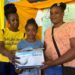 Morvia Reid Williams (L) handing out a nebulizer at medical mission in Little London, Westmoreland.