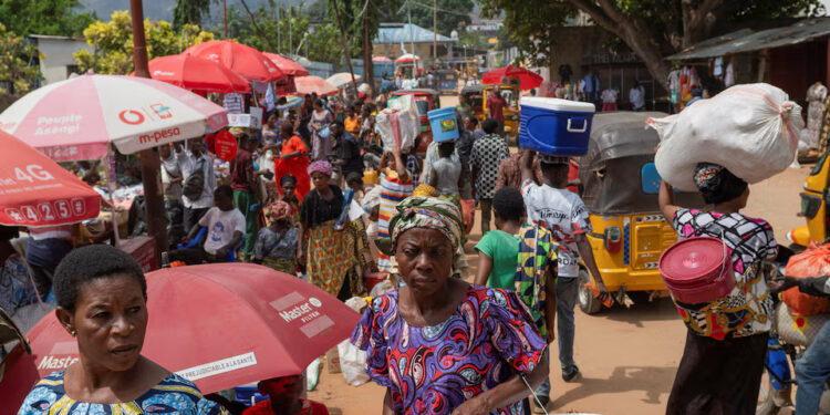 Congolese civilians walk at Maendeleo market as calm returns after clashes between members of the Alliance Fleuve Congo (AFC) and the M23 Movement, who took control of Uvira from the Armed Forces of the Democratic Republic of the Congo (FARDC), in Uvira on the shores of Lake Tanganyika, South Kivu province, Democratic Republic of the Congo, December 15, 2025. REUTERS/Stringer/File Photo Purchase Licensing Rights