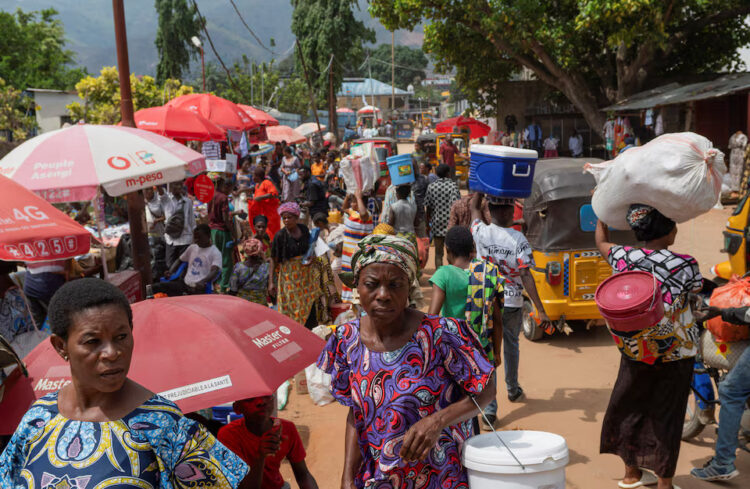 Congolese civilians walk at Maendeleo market as calm returns after clashes between members of the Alliance Fleuve Congo (AFC) and the M23 Movement, who took control of Uvira from the Armed Forces of the Democratic Republic of the Congo (FARDC), in Uvira on the shores of Lake Tanganyika, South Kivu province, Democratic Republic of the Congo, December 15, 2025. REUTERS/Stringer/File Photo Purchase Licensing Rights