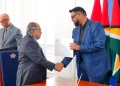 The head of state making the presentation to Justice Rafiq Khan