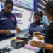 Staff members assist customers at a shop selling electronic products at the East Africa Commercial and Logistics Center (EACLC) in Dar es Salaam, Tanzania, Dec. 19, 2025. (Xinhua/Emmanuel Herman)