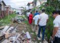 WIN leader, Azruddin Mohamed and team walking through the garbage-filled city