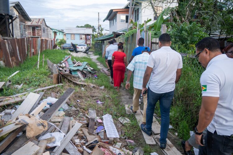 WIN leader, Azruddin Mohamed and team walking through the garbage-filled city