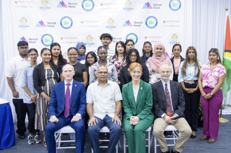 (Front row seated, left to right) ExxonMobil Guyana Limited President Alistair Routledge, representing the Greater Guyana Initiative; Guyana Minister of Health Hon. Dr. Frank Anthony; and Dr. Rachel Vreeman and Dr. Jeb Weisman of the Mount Sinai Health System, with students from the inaugural class of the Guyana Digital Health Training Institute in Georgetown, Guyana. Credit: Courtesy of the Ministry of Health, Guyana
