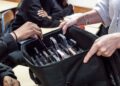 A French secondary school pupil hands in their smartphone ahead of a lesson. /Reuters