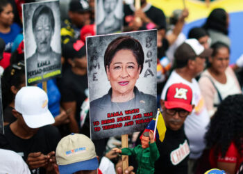 Maduro supporters hold signs with the image of Kamla Persad-Bissessar, prime minister of Trinidad and Tobago, during a demonstration against joint military exercises between the US and Trinidad and Tobago. Photograph: Jesús Vargas/picture-alliance/dpa/AP Images