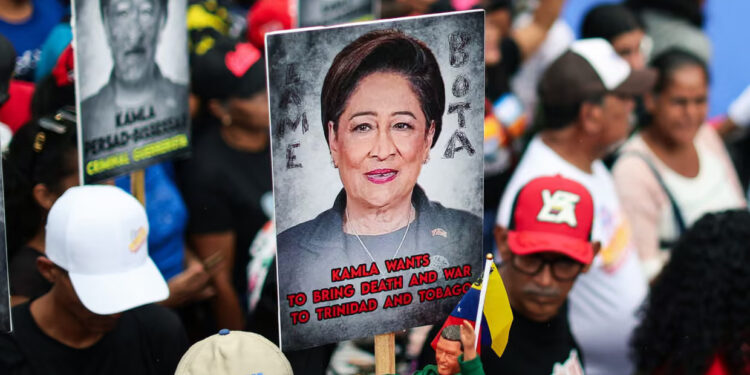 Maduro supporters hold signs with the image of Kamla Persad-Bissessar, prime minister of Trinidad and Tobago, during a demonstration against joint military exercises between the US and Trinidad and Tobago. Photograph: Jesús Vargas/picture-alliance/dpa/AP Images