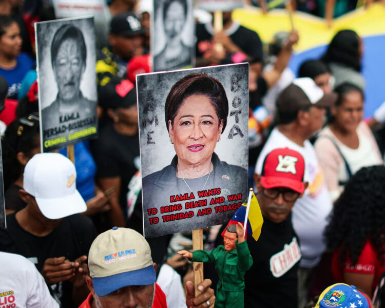 Maduro supporters hold signs with the image of Kamla Persad-Bissessar, prime minister of Trinidad and Tobago, during a demonstration against joint military exercises between the US and Trinidad and Tobago. Photograph: Jesús Vargas/picture-alliance/dpa/AP Images