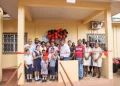 Minister of Health Dr Frank Anthony, along with residents and staff participating in the ribbon cutting