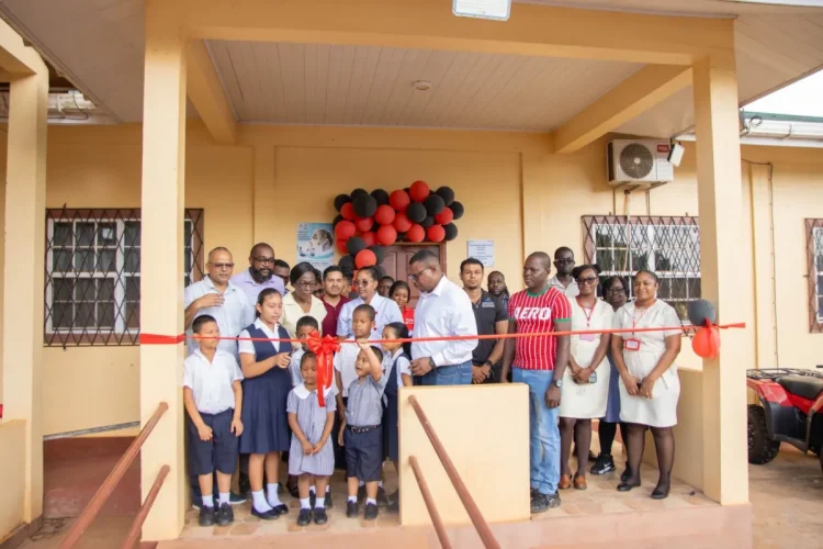 Minister of Health Dr Frank Anthony, along with residents and staff participating in the ribbon cutting
