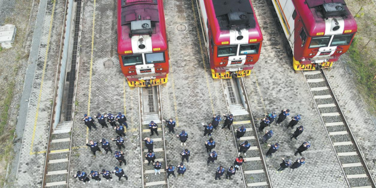 Railway workers from China and Kenya stand before locomotives and form the number "3000" at the locomotive operation and maintenance yard in Nairobi on Aug 19, marking 3,000 days of safe operation of the Mombasa-Nairobi Standard Gauge Railway. YANG GUANG/XINHUA