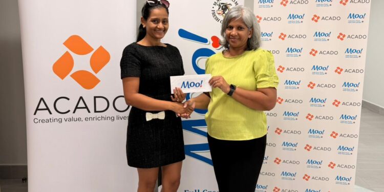 Marcia Lee (R) Receiving Sponsorship from Ms. Alicia DeAbreu, CEO of ACADO Guyana