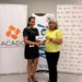 Marcia Lee (R) Receiving Sponsorship from Ms. Alicia DeAbreu, CEO of ACADO Guyana