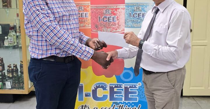 Mr. Clayton McKenzie (L), I-CEE Brand Manager presents sponsorship cheque to Mr. Shiv Nandalall, PR Director of the Guyana Chess Federation (GCF) at the Banks DIH Thirst Park location.