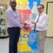 Mr. Clayton McKenzie (L), I-CEE Brand Manager presents sponsorship cheque to Mr. Shiv Nandalall, PR Director of the Guyana Chess Federation (GCF) at the Banks DIH Thirst Park location.