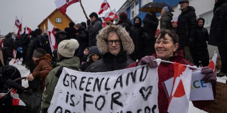 People attend a protest against U.S. President Donald Trump's demand that the Arctic island be ceded to the U.S., calling for it to be allowed to determine its own future, in front of the U.S. consulate in Nuuk, Greenland, January 17, 2026. REUTERS/Marko Djurica Purchase Licensing Rights
