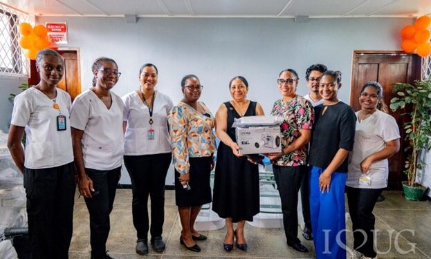 From front, first left, Lead, Greater Guyana Initiative, Mrs Alicia Bess-Anderson; third left, Philanthropy Officer/ Procurement Compliance Specialist, Mr Desmond Leitch, University of Guyana; Assistant Dean, College of Medical Sciences, Dr Andrew Hutson. First from right, , Principal Officer, Ministry of Health, Dr Marvin Monise; Director, School of Dentistry, Dr Ruematta Overton; Vice-Chancellor of the University of Guyana, Professor Paloma Mohamed Martin; and Deputy Vice-Chancellor for Academic Engagement, Professor Emanuel Cummings; along with other staff of the University of Guyana, representatives of the Greater Guyana Initiative, and students of the School of Dentistry at the handing-over ceremony held at the University of Guyana’s Old College of Medical Sciences Building.