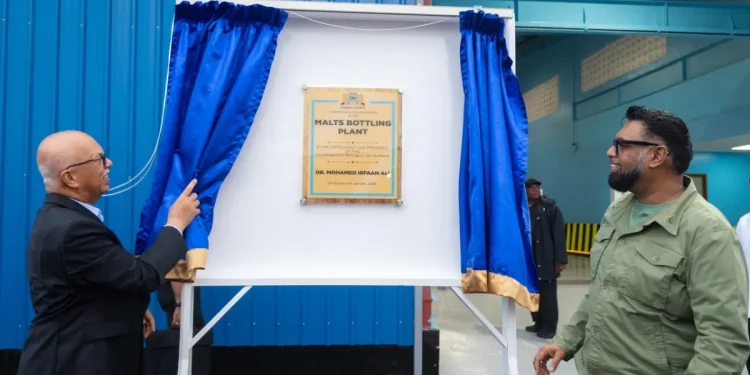 President Mohamed Irfaan Ali and Chairman of Banks DIH Clifford Reis unveil the commemorative plaque