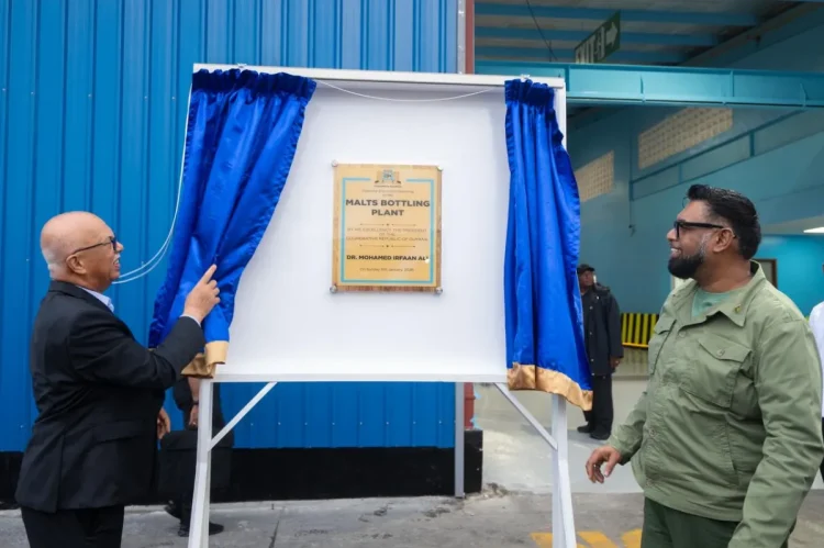 President Mohamed Irfaan Ali and Chairman of Banks DIH Clifford Reis unveil the commemorative plaque