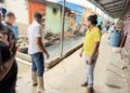 WIN Leader Azruddin Mohamed (in long boots) and others looking at the Bourda Market environment
