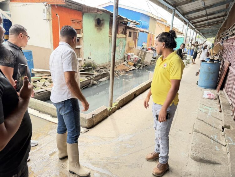 WIN Leader Azruddin Mohamed (in long boots) and others looking at the Bourda Market environment