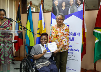 CARICOM Secretary-General Dr Barnett presenting a certificate to Yanique Mendez of Jamaica during the launch of the CARICOM Young Professional Network (CYPN) in October 2025
