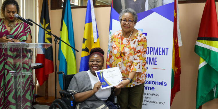 CARICOM Secretary-General Dr Barnett presenting a certificate to Yanique Mendez of Jamaica during the launch of the CARICOM Young Professional Network (CYPN) in October 2025