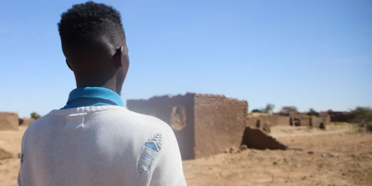 Dr. Mohamed Ibrahim, who asked for his face not to be shown, walk at the Rwanda refugee camp in Darfur, Sudan  Dec. 22. 2025 (AP Photo /Marwan Mohamed)