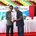 Minister Anil Nandlall (l) handing over Certificate of Title to a Cotton Tree resident (DPI photo)