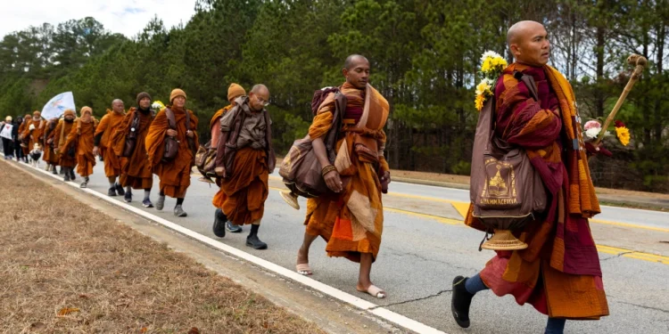 Buddhist monks on a “Walk for Peace” walk on Veterans Parkway in Fayetteville, Ga., on Monday, Dec. 29, 2025, from Texas to Washington, D.C. (Arvin Temkar/Atlanta Journal-Constitution via AP)