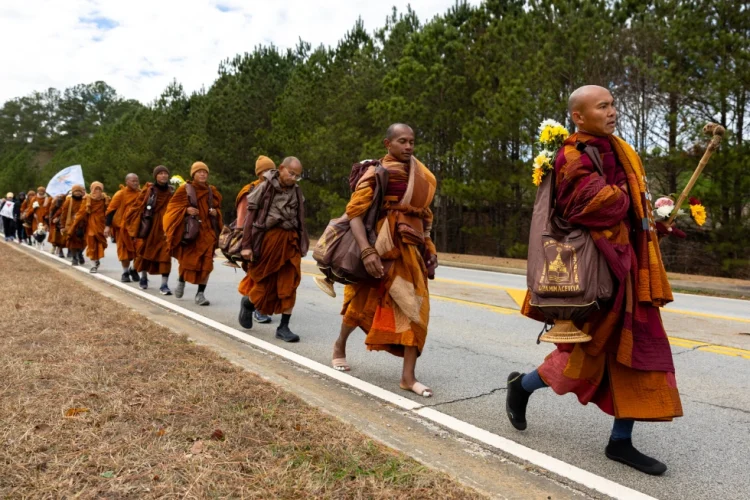 Buddhist monks on a “Walk for Peace” walk on Veterans Parkway in Fayetteville, Ga., on Monday, Dec. 29, 2025, from Texas to Washington, D.C. (Arvin Temkar/Atlanta Journal-Constitution via AP)
