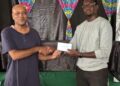 1st Place Winner FM Rawle Allicock ( L) receiving his reward from Oluwadare Oyeyipo, Gambit Group.