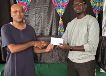 1st Place Winner FM Rawle Allicock ( L) receiving his reward from Oluwadare Oyeyipo, Gambit Group.