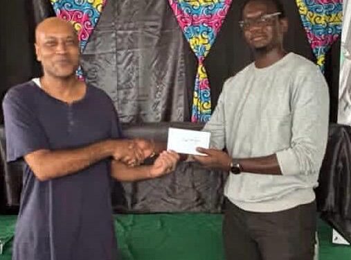 1st Place Winner FM Rawle Allicock ( L) receiving his reward from Oluwadare Oyeyipo, Gambit Group.
