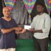 1st Place Winner FM Rawle Allicock ( L) receiving his reward from Oluwadare Oyeyipo, Gambit Group.