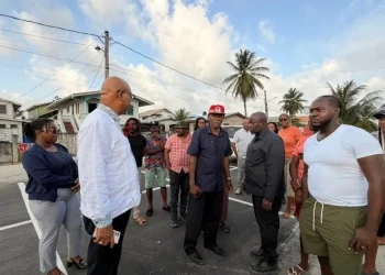 Minister of Public Works Bishop Juan Edghill engages B Field Sophia vendors on Tuesday