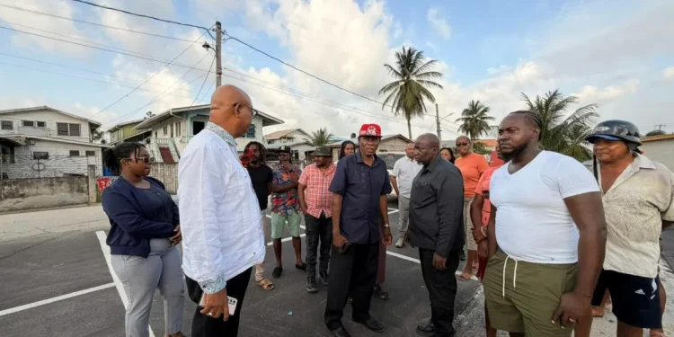 Minister of Public Works Bishop Juan Edghill engages B Field Sophia vendors on Tuesday