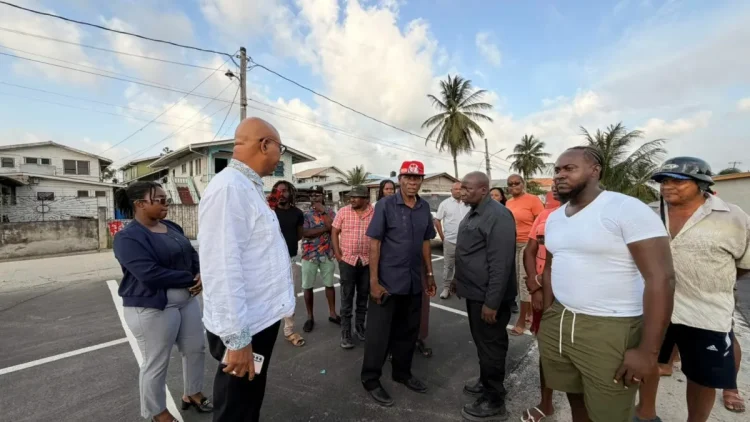 Minister of Public Works Bishop Juan Edghill engages B Field Sophia vendors on Tuesday