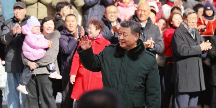 President Xi Jinping, also general secretary of the Communist Party of China Central Committee and chairman of the Central Military Commission, waves to the crowd while visiting the Longfusi commercial area in Dongcheng district of Beijing, Feb 10, 2026. [Photo/Xinhua]