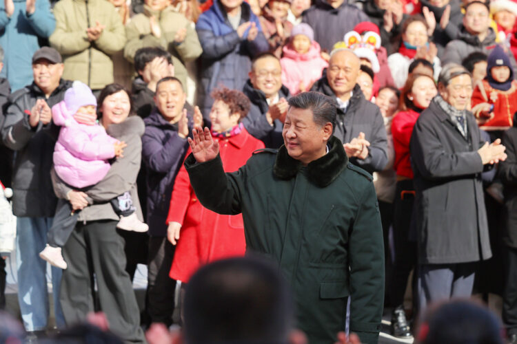 President Xi Jinping, also general secretary of the Communist Party of China Central Committee and chairman of the Central Military Commission, waves to the crowd while visiting the Longfusi commercial area in Dongcheng district of Beijing, Feb 10, 2026. [Photo/Xinhua]