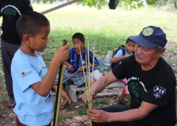 A child learning a Traditional skill in Shulinab Village. Credit - Neal Millar