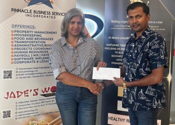 Mrs. Marcia Lee (L), GCF Company Secretary receives sponsorship cheque from Mr. Lucknauth (R) proprietor of Jade's Wok