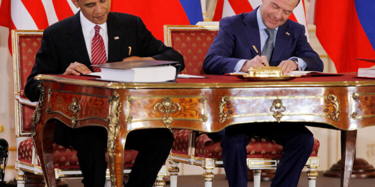 [2/2] Barack Obama (L) and Dmitry Medvedev, who were then the U.S. and Russian presidents, sign the new Strategic Arms Reduction Treaty (START II) at Prague Castle in Prague April 8, 2010. REUTERS/Jason Reed/File Photo Purchase Licensing Rights