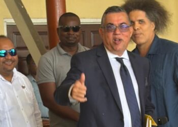 State Prosecutor Glen Hanoman (in tie) and Mikhail “Critic” Rodrigues,