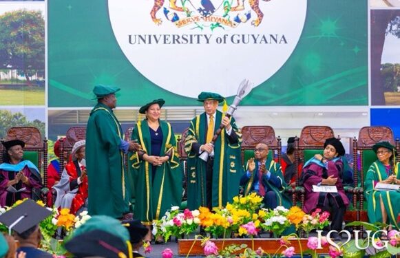 Newly installed Chancellor of the University of Guyana, Sir Ronald Sanders, receives the Mace from Vice-Chancellor Professor Paloma Mohamed-Martin and Chief Marshall, after being administered the Oath of Office during the formal installation ceremony at the George Walcott Lecture Theatre, University of Guyana