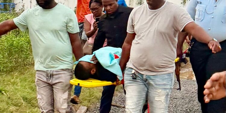 Christopher Ali being transported to the New Amsterdam Hospital after being brought out injured from the Berbice River