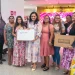 Minister of Human Services and Social Security, Dr Vindhya Persaud poses with some of the beneficiaries of the starter packs