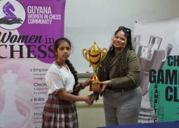 Eleven-year-old Divya Persaud took home the first-place trophy for her standout performance at the Women’s Day Rapid Chess Tournament hosted by the Gambit Group. The event, a collaboration among the Gambit Group, Guyana Chess Federation’s Women in Chess, and the School of the Nations, was held on Friday, March 6, 2026, to commemorate International Women’s Day. A total of 24 females accepted the invitation to compete from various schools, including School of the Nations, Marian Academy, St. Joseph High, St. Rose's High, Christ Church Secondary, Richard Ishmael Secondary, New Guyana School, St. John’s College, and Mae’s Primary School.
Persaud, a student at the New Guyana School and the reigning National U12 Girls Rapid Champion, is rapidly cementing her status as one of Guyana’s premier junior chess talents. She dominated the tournament with an impressive, unbeaten score of 6 points, navigating the field with four wins and two strategic draws. Marian Academy’s Tharisha Montes De Oca, no stranger to the chess board, secured second place with 5 points, while schoolmate Angelina Yhap finished third, also with 5 points. Montes De Oca and Yhap have been playing chess for several years and are gradually moving up the ranks of top junior females.
The fourth place and Best U16 player prize was won by New Guyana School’s Lusianna Farlot, while St. Rose’s High’s Gabrielle Mohabir took home the fifth place and Best U14 player award. Amaya Sharma, from the School of the Nations, secured sixth and the Best U12 player prize.
Medals were also awarded to Shameera Dwarka from Christ Church Secondary, Anaya Lall, Maya Ali from School of the Nations, and St. Joseph High’s Madison Spencer, who placed seventh through tenth, respectively.
The girls all showcased their talent and strategic moves in the seven round ten minute Rapid chess competition.
The trophies and medals were awarded to the top performers by WCM Sasha Shariff, a member of the Gambit Group, during a brief ceremony.
A special thank you goes to the organizing team led by Gambit Group’s founder, Oluwadare Oyeyipo. Along with arbiters Marcia Lee, Keron Sandiford, WCM Jessica Callender, and Nathan Williams. Their tireless work behind the scenes ensured that the tournament was conducted fairly and in strict accordance with the rules. Gratitude is extended to Callender for capturing the tournament photos.
A special thank you is extended to the School of the Nations for providing the tournament venue.