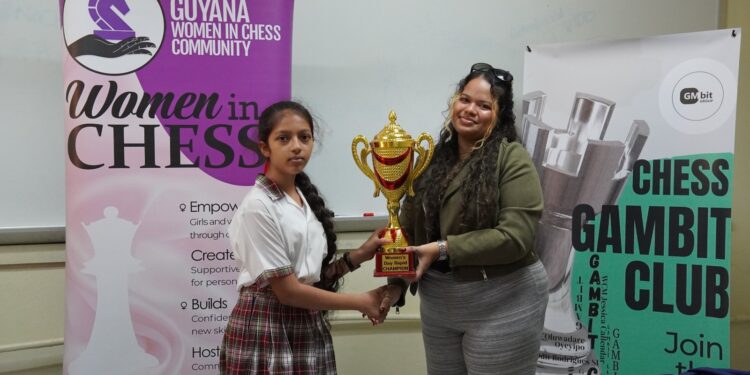 Eleven-year-old Divya Persaud took home the first-place trophy for her standout  performance at the Women’s Day Rapid Chess Tournament hosted by the  Gambit Group. The event, a collaboration among the Gambit Group, Guyana  Chess Federation’s Women in Chess, and the School of the Nations, was held on  Friday, March 6, 2026, to commemorate International Women’s Day. A total of  24 females accepted the invitation to compete from various schools, including  School of the Nations, Marian Academy, St. Joseph High, St. Rose's High, Christ  Church Secondary, Richard Ishmael Secondary, New Guyana School, St. John’s  College, and Mae’s Primary School. 
Persaud, a student at the New Guyana School and the reigning National U12 Girls  Rapid Champion, is rapidly cementing her status as one of Guyana’s premier  junior chess talents. She dominated the tournament with an impressive,  unbeaten score of 6 points, navigating the field with four wins and two strategic  draws. Marian Academy’s Tharisha Montes De Oca, no stranger to the chess  board, secured second place with 5 points, while schoolmate Angelina Yhap  finished third, also with 5 points. Montes De Oca and Yhap have been playing  chess for several years and are gradually moving up the ranks of top junior  females. 
The fourth place and Best U16 player prize was won by New Guyana School’s  Lusianna Farlot, while St. Rose’s High’s Gabrielle Mohabir took home the fifth  place and Best U14 player award. Amaya Sharma, from the School of the Nations,  secured sixth and the Best U12 player prize. 
Medals were also awarded to Shameera Dwarka from Christ Church Secondary,  Anaya Lall, Maya Ali from School of the Nations, and St. Joseph High’s Madison  Spencer, who placed seventh through tenth, respectively. 
The girls all showcased their talent and strategic moves in the seven round ten minute Rapid chess competition.  
The trophies and medals were awarded to the top performers by WCM Sasha  Shariff, a member of the Gambit Group, during a brief ceremony.
A special thank you goes to the organizing team led by Gambit Group’s founder,  Oluwadare Oyeyipo. Along with arbiters Marcia Lee, Keron Sandiford, WCM  Jessica Callender, and Nathan Williams. Their tireless work behind the scenes  ensured that the tournament was conducted fairly and in strict accordance with  the rules. Gratitude is extended to Callender for capturing the tournament  photos. 
A special thank you is extended to the School of the Nations for providing the  tournament venue.